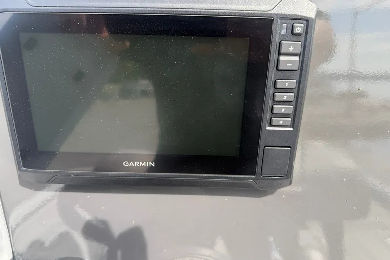 Slide: The Image of Garmin display on 2026 Avid 20 Rogue CC boat dashboard, featuring control buttons. - 17