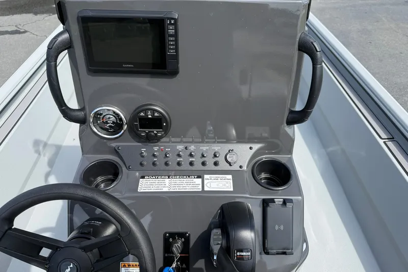 Slide: The Image of Dashboard of 2026 Avid 20 Rogue CC boat with steering wheel and controls. - 16
