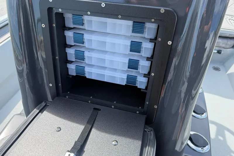 Slide: The Image of Storage compartment with tackle boxes in 2026 Avid 20 Rogue CC boat. - 21