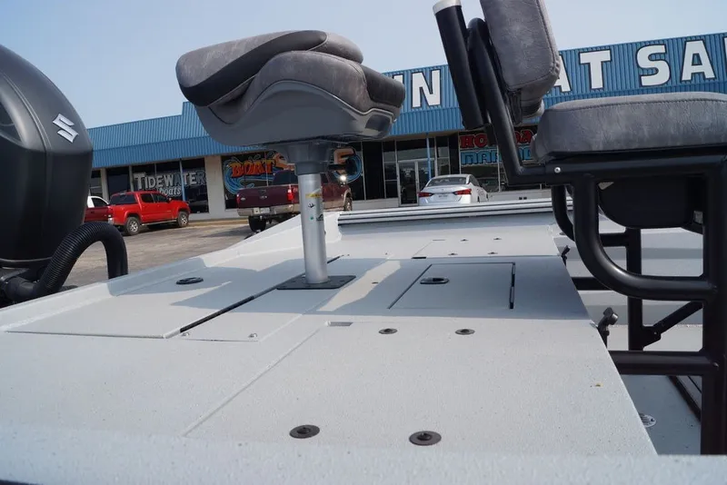Slide: The Image of 2026 Excel 220 Bay Pro Elite boat with seating, displayed at a dealership. - 10