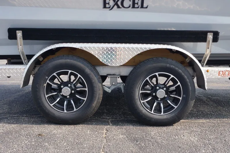 Slide: The Image of Trailer wheels of 2026 Excel 220 Bay Pro Elite boat on pavement. - 3