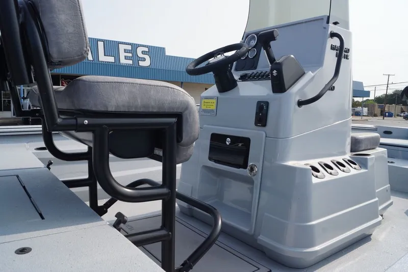 Slide: The Image of 2026 Excel 220 Bay Pro Elite boat interior with steering console and seating. - 8