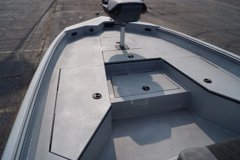 Slide: The Image of 2026 Excel 220 Bay Pro Elite boat deck with storage compartments and seating. - 16