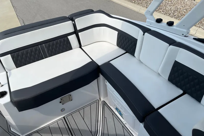 Slide: The Image of 2025 Monterey M6 boat interior with sleek black and white seating design. - 19