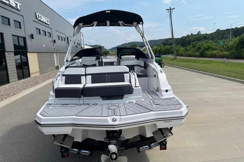 Slide: The Image of 2025 Monterey M6 boat with sleek design, parked outdoors near a modern building. - 9
