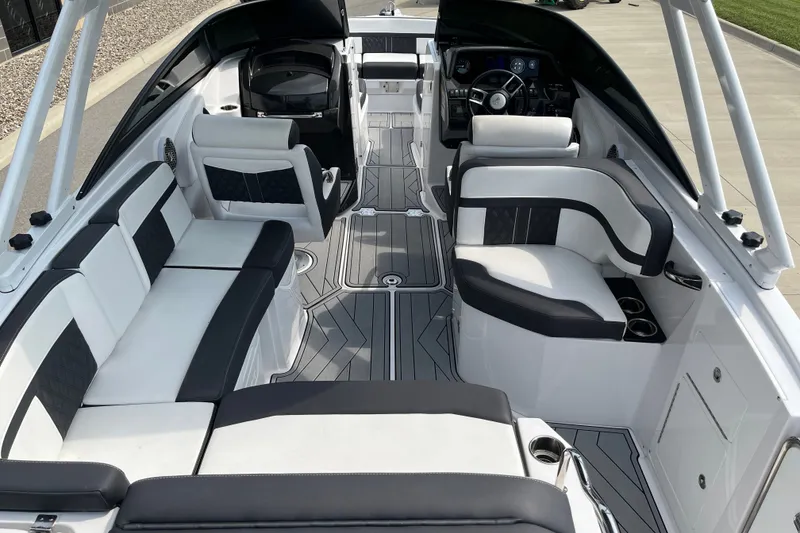 Slide: The Image of 2025 Monterey M6 boat interior with sleek black and white seating and modern dashboard. - 10