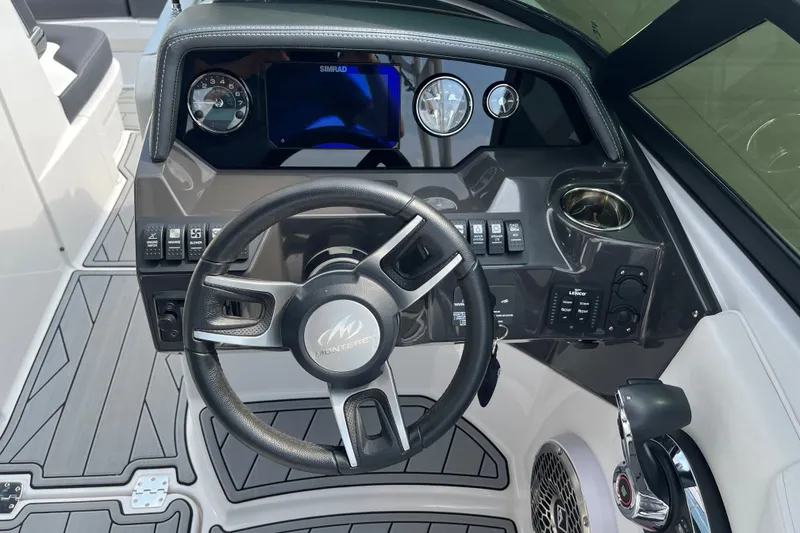 Slide: The Image of 2025 Monterey M6 boat dashboard with steering wheel, controls, and Simrad display. - 12