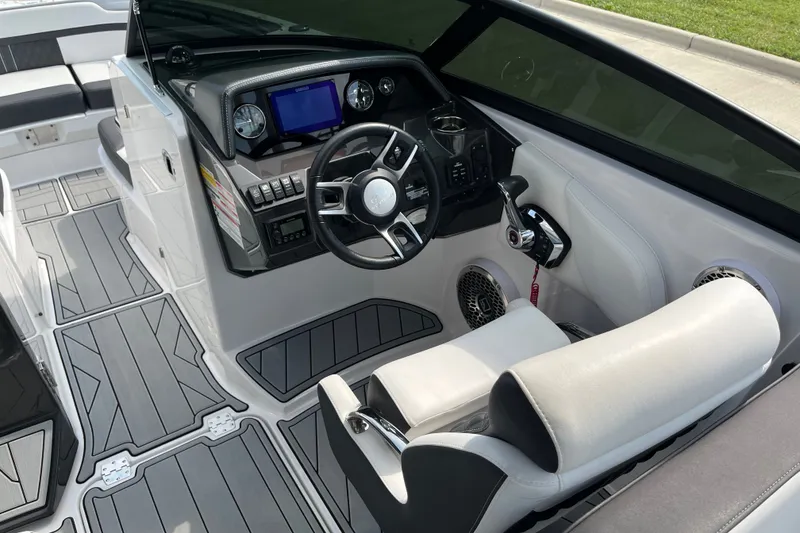Slide: The Image of Interior of 2025 Monterey M6 boat with modern dashboard and steering wheel. - 11
