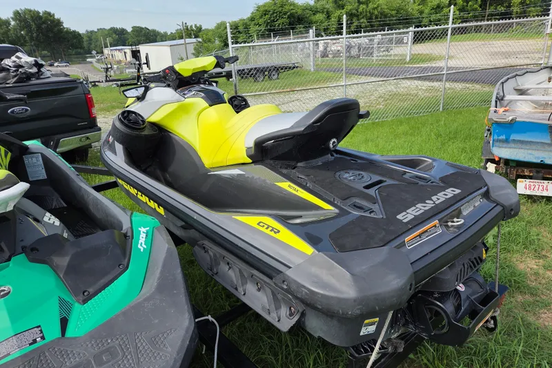 Slide: The Image of 2020 Sea Doo GTR 230 jet ski in vibrant yellow and black, parked outdoors. - 2