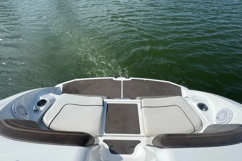 Slide: The Image of 2012 Yamaha Boats 242 Limited S rear deck view on water. - 16
