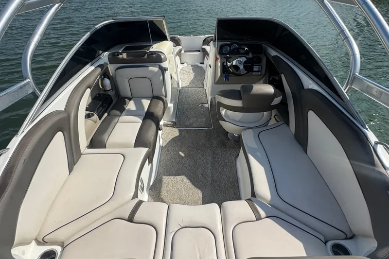 Slide: The Image of 2012 Yamaha Boats 242 Limited S interior with spacious seating and sleek design on the water. - 17