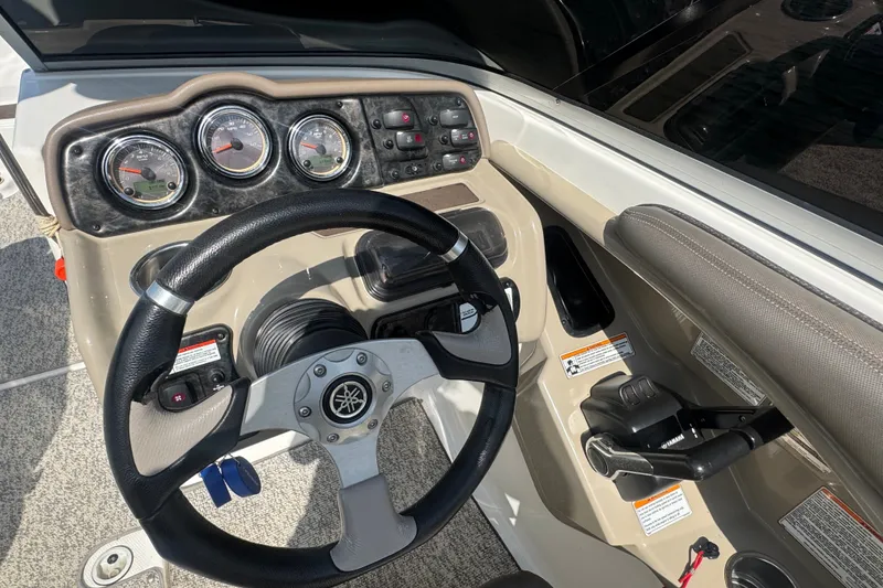 Slide: The Image of 2012 Yamaha Boats 242 Limited S dashboard with steering wheel and control panel. - 11