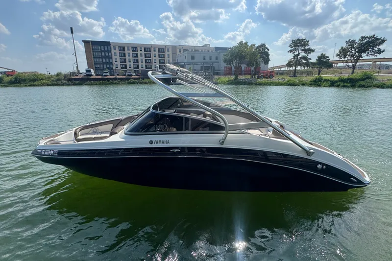 The Image of 2012 Yamaha Boats 242 Limited S on calm water under a partly cloudy sky. - 1