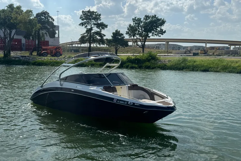 Slide: The Image of 2012 Yamaha Boats 242 Limited S on a sunny lake, surrounded by greenery. - 5