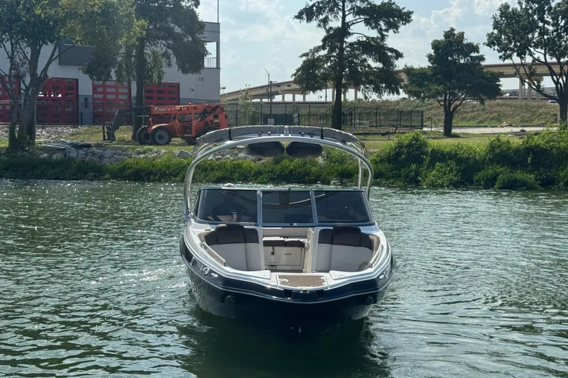 Slide: The Image of 2012 Yamaha Boats 242 Limited S on a scenic river with trees and buildings in the background. - 6