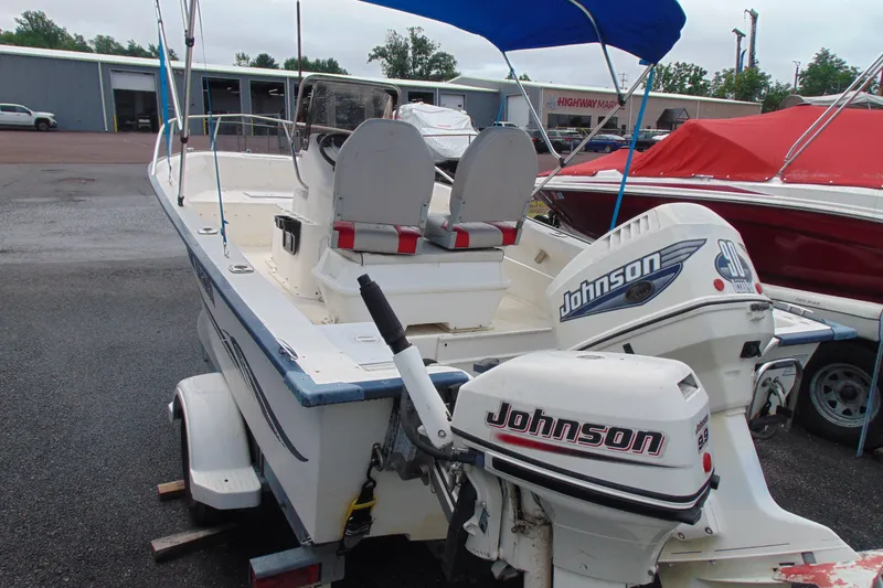 Slide: The Image of 2003 Palm Beach 181 WHITECAP boat with Johnson outboard motors, parked on a trailer. - 3