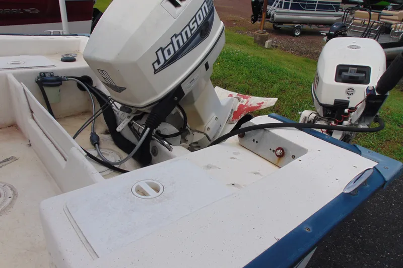 Slide: The Image of 2003 Palm Beach 181 WHITECAP boat with Johnson outboard motor, docked on grass. - 5