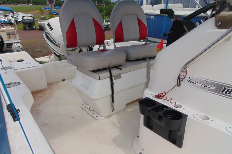 Slide: The Image of 2003 Palm Beach 181 WHITECAP boat interior with seating and Johnson outboard motor. - 10