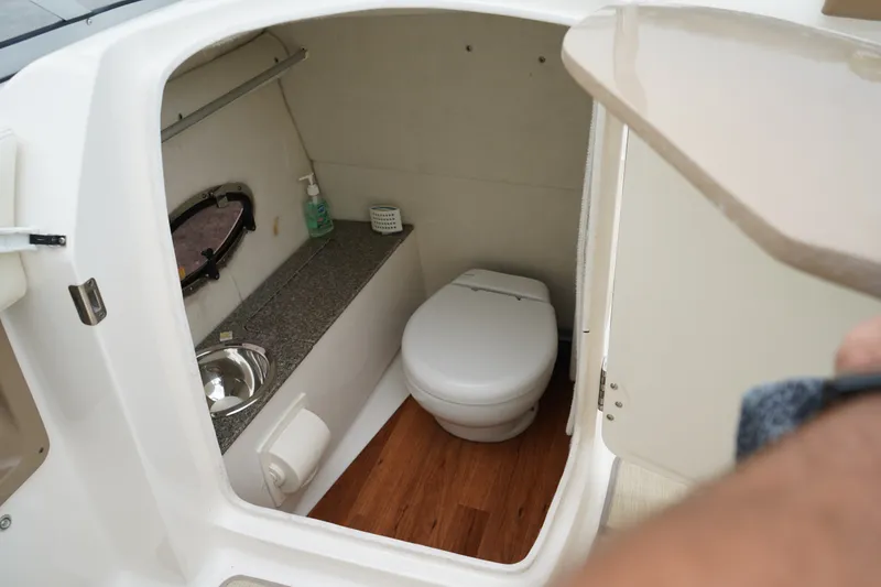 Slide: The Image of Interior of 2015 Chaparral 230 Suncoast boat bathroom with sink and toilet. - 8