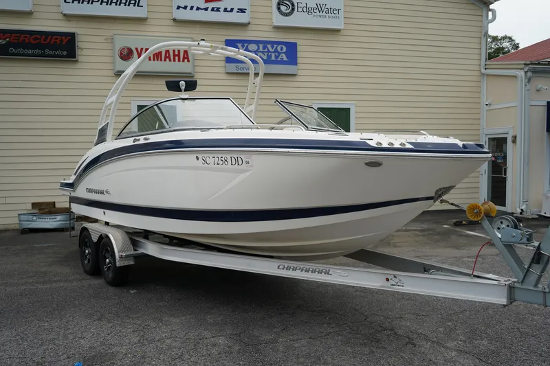 Slide: The Image of 2015 Chaparral 230 Suncoast boat on trailer, parked outside dealership. - 2