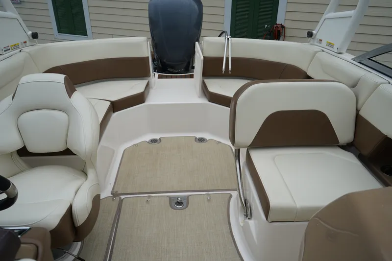 Slide: The Image of Interior view of 2015 Chaparral 230 Suncoast boat with beige and brown seating. - 11