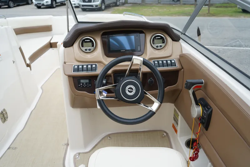 Slide: The Image of 2015 Chaparral 230 Suncoast boat dashboard with steering wheel and control panel. - 13