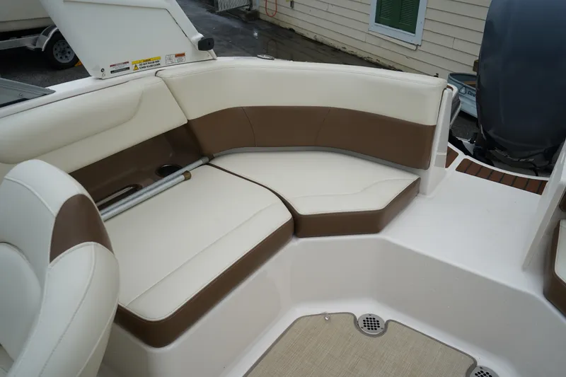 Slide: The Image of 2015 Chaparral 230 Suncoast boat interior with brown and white seating. - 7
