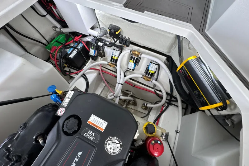 Slide: The Image of Engine compartment of a 2021 Cobalt R8 Surf boat, showcasing wiring and components. - 35
