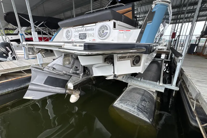 Slide: The Image of 2021 Cobalt R8 Surf boat docked, showcasing propeller and Surf Gate system. - 38