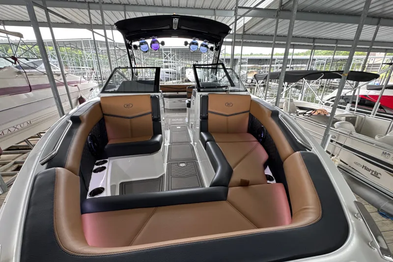 Slide: The Image of 2021 Cobalt R8 Surf boat interior with luxurious seating and modern design in a marina. - 8