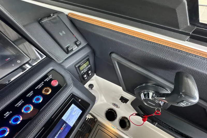 Slide: The Image of 2021 Cobalt R8 Surf boat dashboard with controls and wireless charging pad. - 15