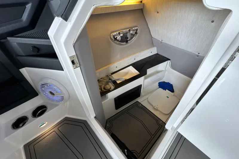 Slide: The Image of 2021 Cobalt R8 Surf boat interior cabin with modern amenities and sleek design. - 21