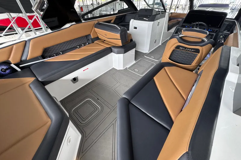 Slide: The Image of 2021 Cobalt R8 Surf boat interior with luxurious tan and black seating. - 7