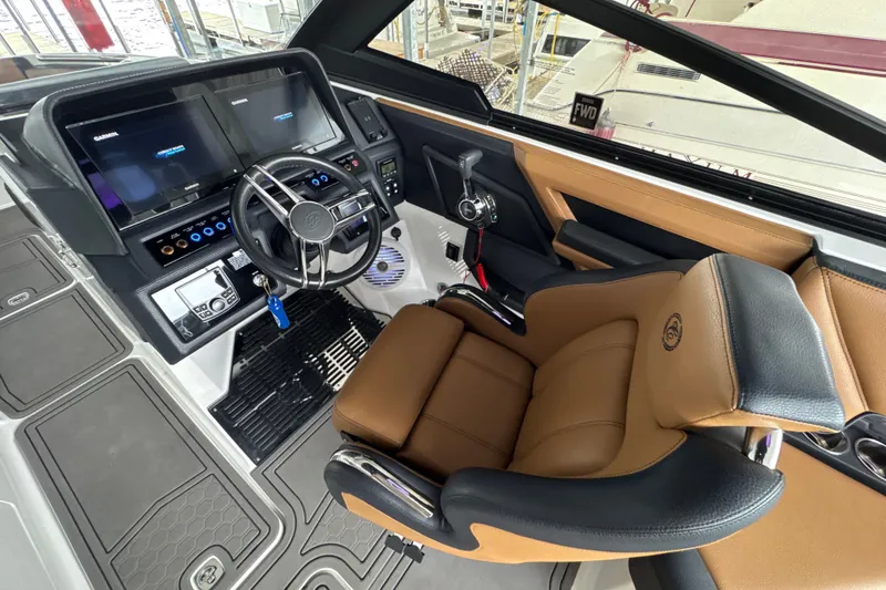 Slide: The Image of 2021 Cobalt R8 Surf boat cockpit with modern controls and luxurious seating. - 13