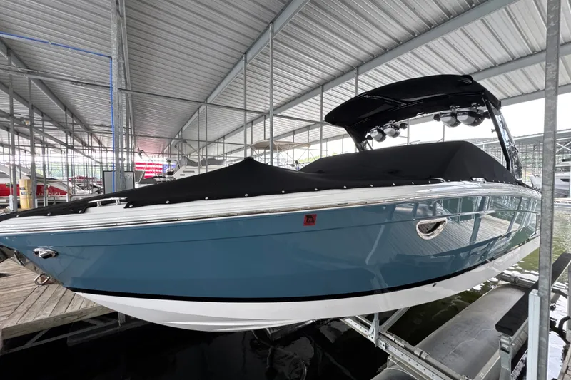 Slide: The Image of 2021 Cobalt R8 Surf boat in marina, covered and docked under a metal roof. - 3