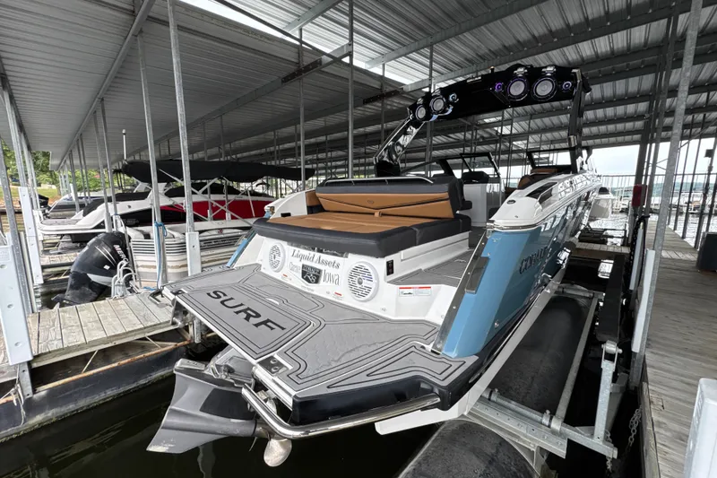 Slide: The Image of 2021 Cobalt R8 Surf boat docked in a covered marina. - 5