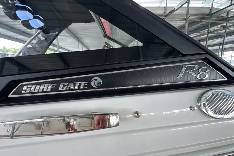 Slide: The Image of 2021 Cobalt R8 Surf boat with Surf Gate feature in a covered marina. - 40