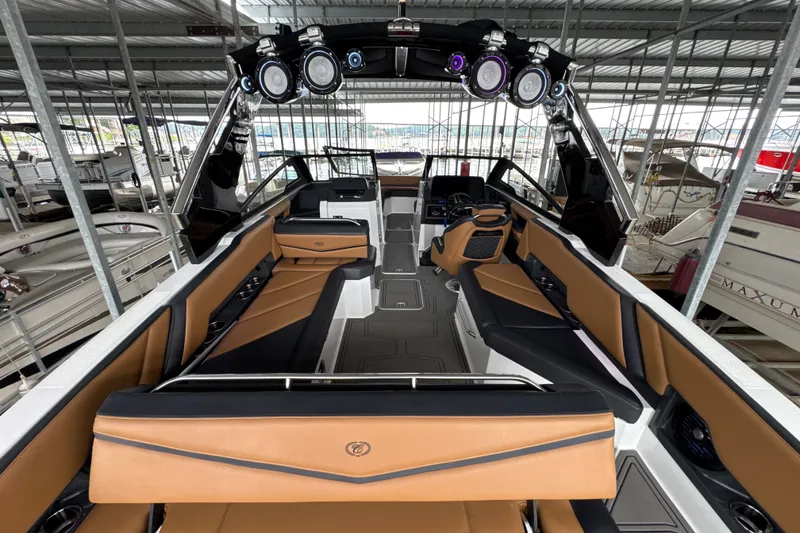 Slide: The Image of 2021 Cobalt R8 Surf boat interior with tan and black seating, advanced audio system, and sleek design. - 9