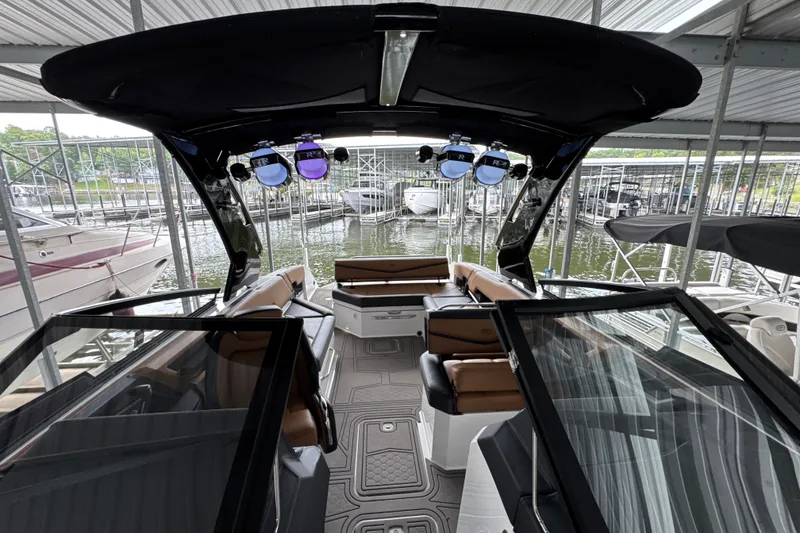 Slide: The Image of 2021 Cobalt R8 Surf boat interior with luxurious seating and modern design in a marina. - 31
