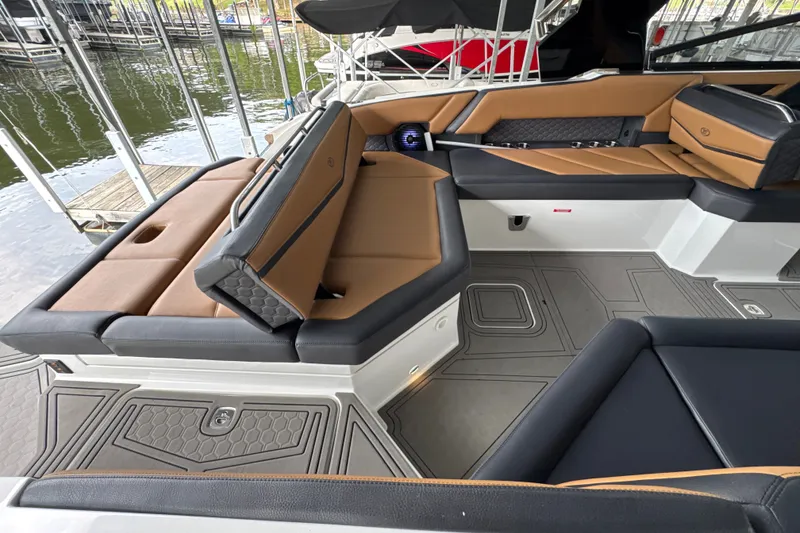 Slide: The Image of 2021 Cobalt R8 Surf boat interior with luxurious tan and black seating. - 29