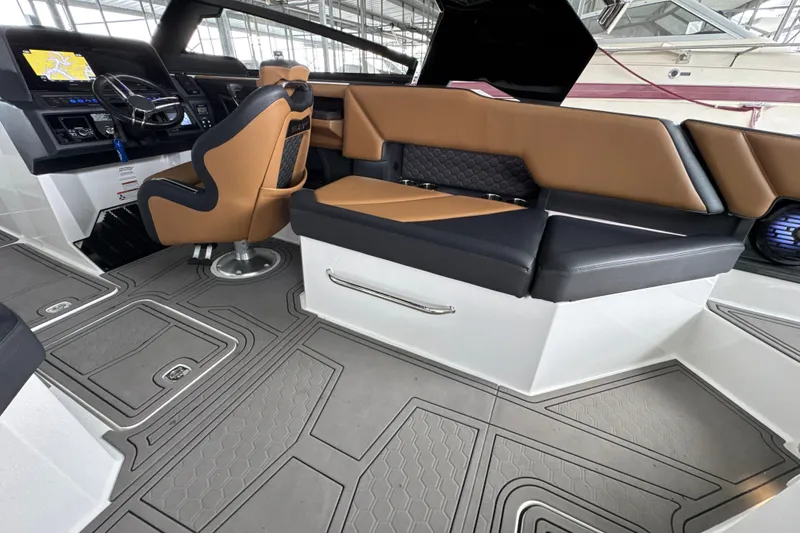 Slide: The Image of 2021 Cobalt R8 Surf boat interior with tan and black seating, modern dashboard. - 28
