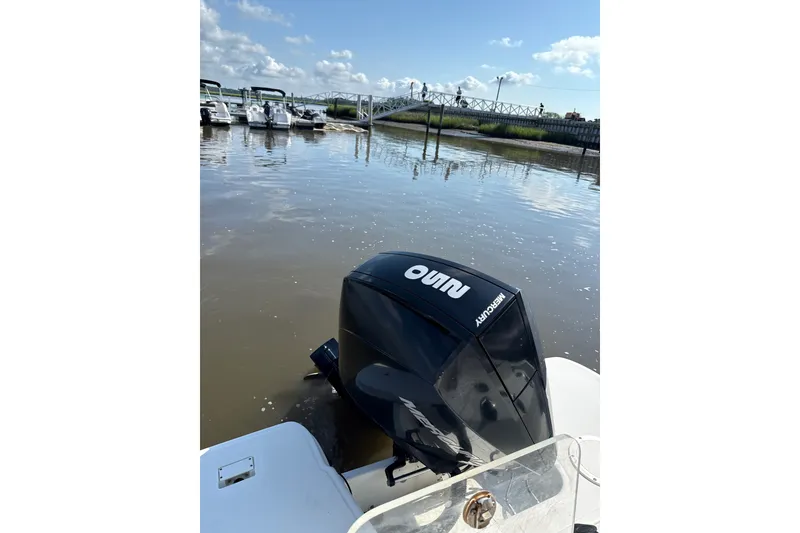 Slide: The Image of Outboard motor on a 2023 Trophy CC24 boat docked by a marina. - 9