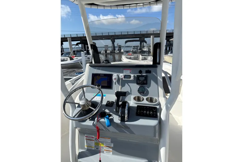 Slide: The Image of 2023 Trophy CC24 boat dashboard with steering wheel and navigation controls. - 4