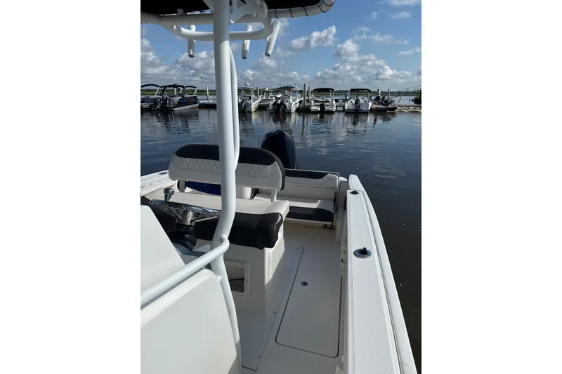 Slide: The Image of 2023 Trophy CC24 boat docked at marina under blue sky. - 5