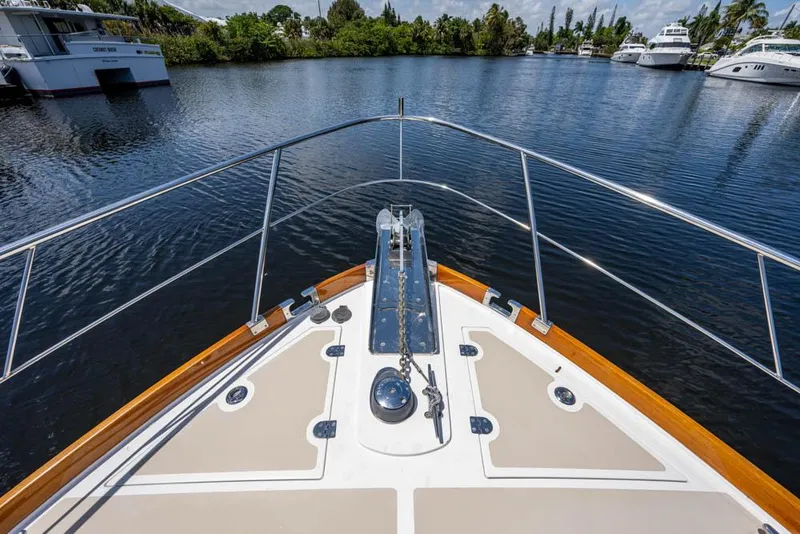 Slide: The Image of Bow view of the 2007 Grand Banks 43 Eastbay SX, featuring an anchor and calm water. - 14