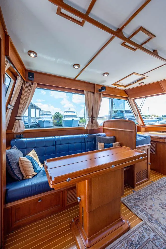 Slide: The Image of Interior of the 2007 Grand Banks 43 Eastbay SX with wooden table and blue upholstery. - 28