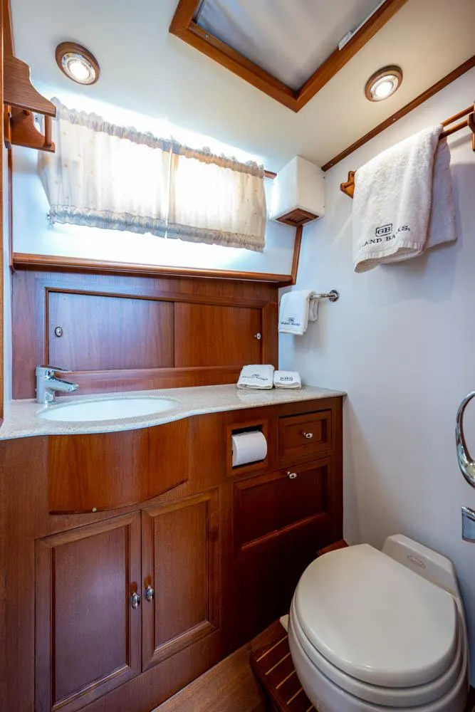 Slide: The Image of The image shows an elegant bathroom with wooden cabinetry and a sink. - 44