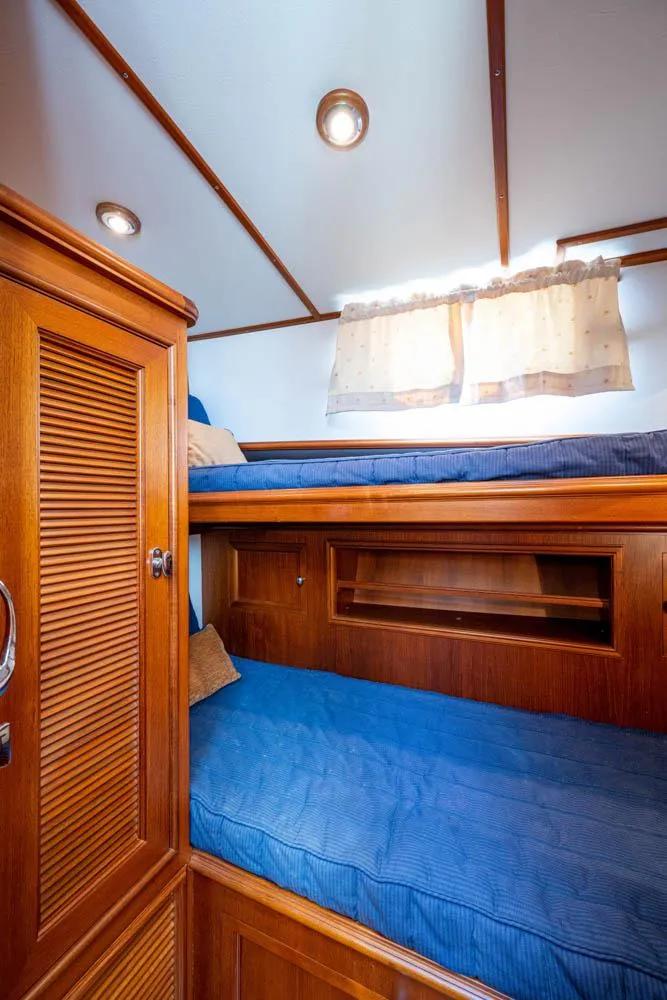 Slide: The Image of The 2007 Grand Banks 43 Eastbay SX cabin features bunk beds and wooden furnishings. - 41