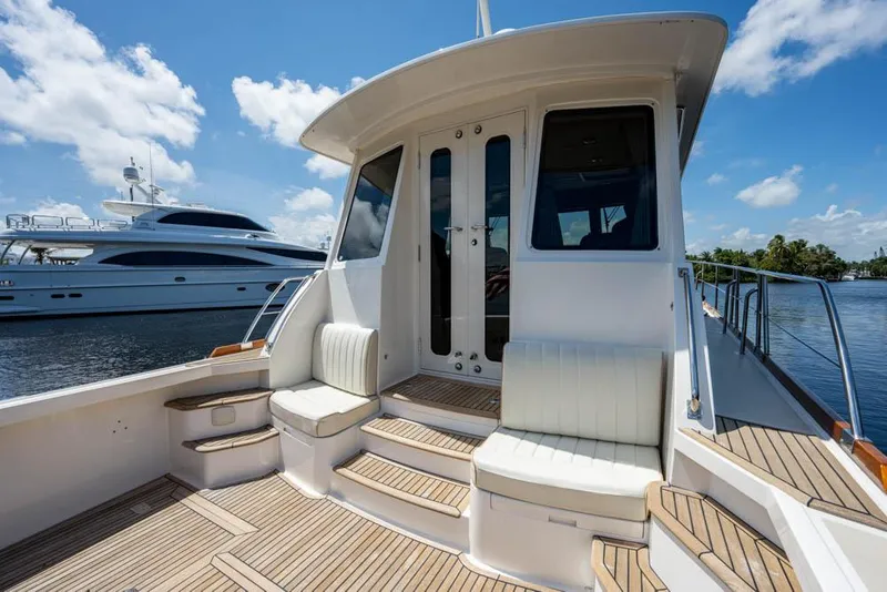 Slide: The Image of Grand Banks 43 Eastbay SX 2007: Elegant exterior deck with wooden flooring and comfortable seating. - 24
