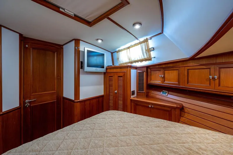 Slide: The Image of Cabin of the 2007 Grand Banks 43 Eastbay SX with wood furnishings and a TV. - 37